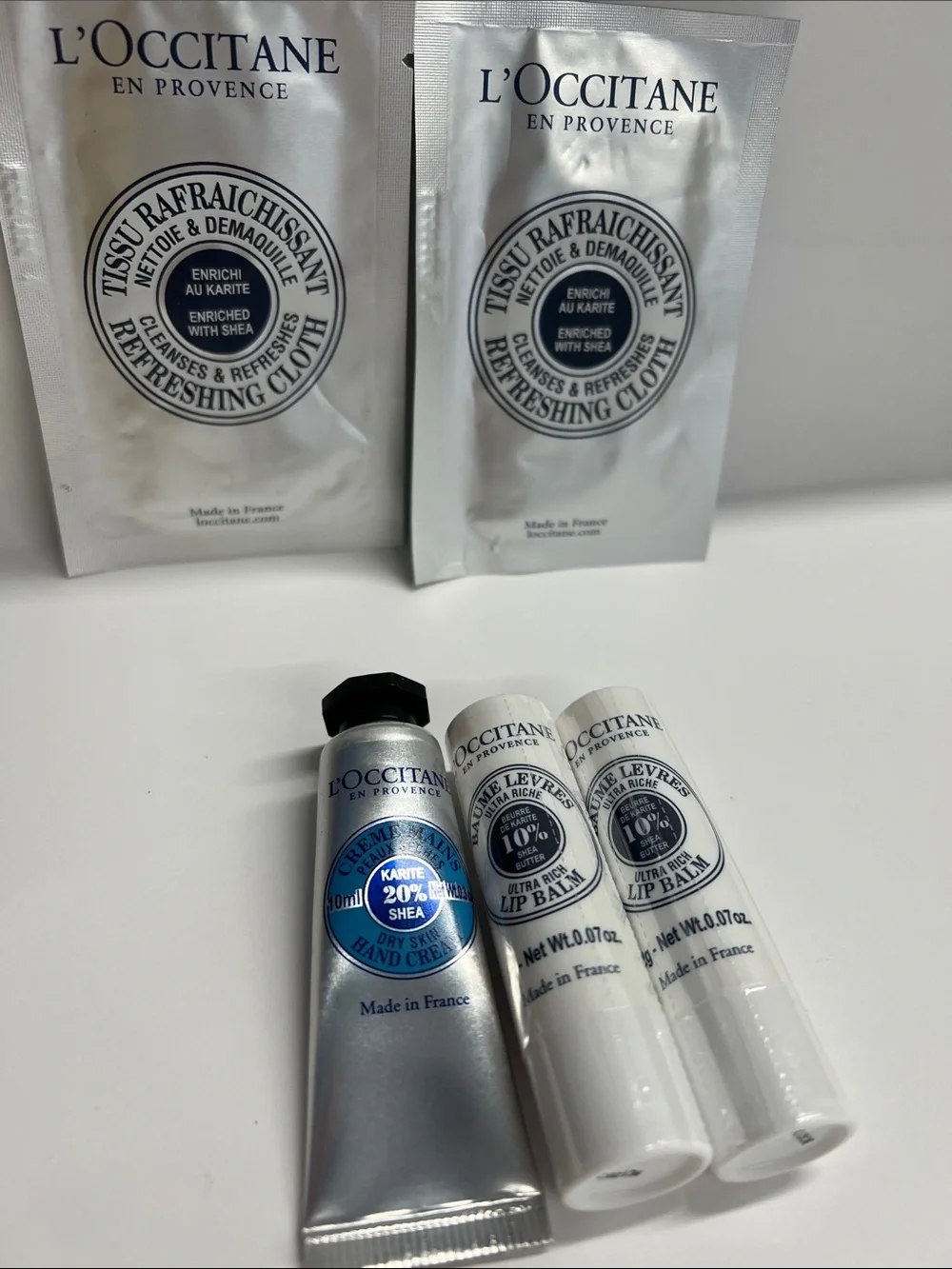 L’Occitane set of 5 travel Items Handcream, 2 lip balms and 2 Refresh Cloths New